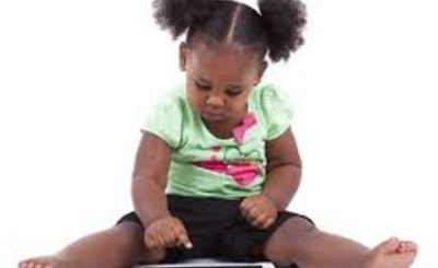 A child tapping on a tablet