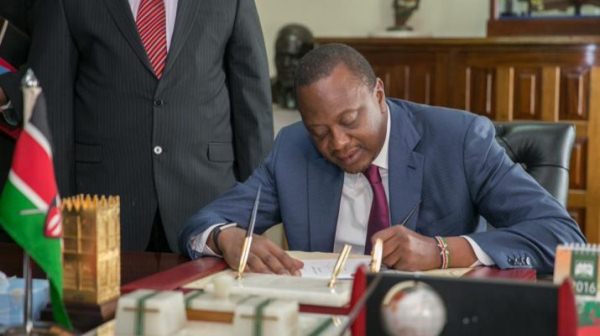 President Kenyatta signing the cybercrimes bill
